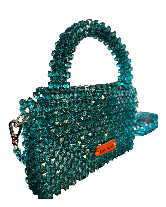 mini handbag adorned with quality fake stones in a captivating transparent green. The stones, meticulously selected for their brilliance, radiate sophistication and elegance. The bag boasts a transformative design with a removable chain, allowing it to seamlessly transition from a shoulder bag to a sophisticated handbag. Despite its petite size, this accessory exudes opulence and glamour, serving as a statement piece that complements a variety of looks.