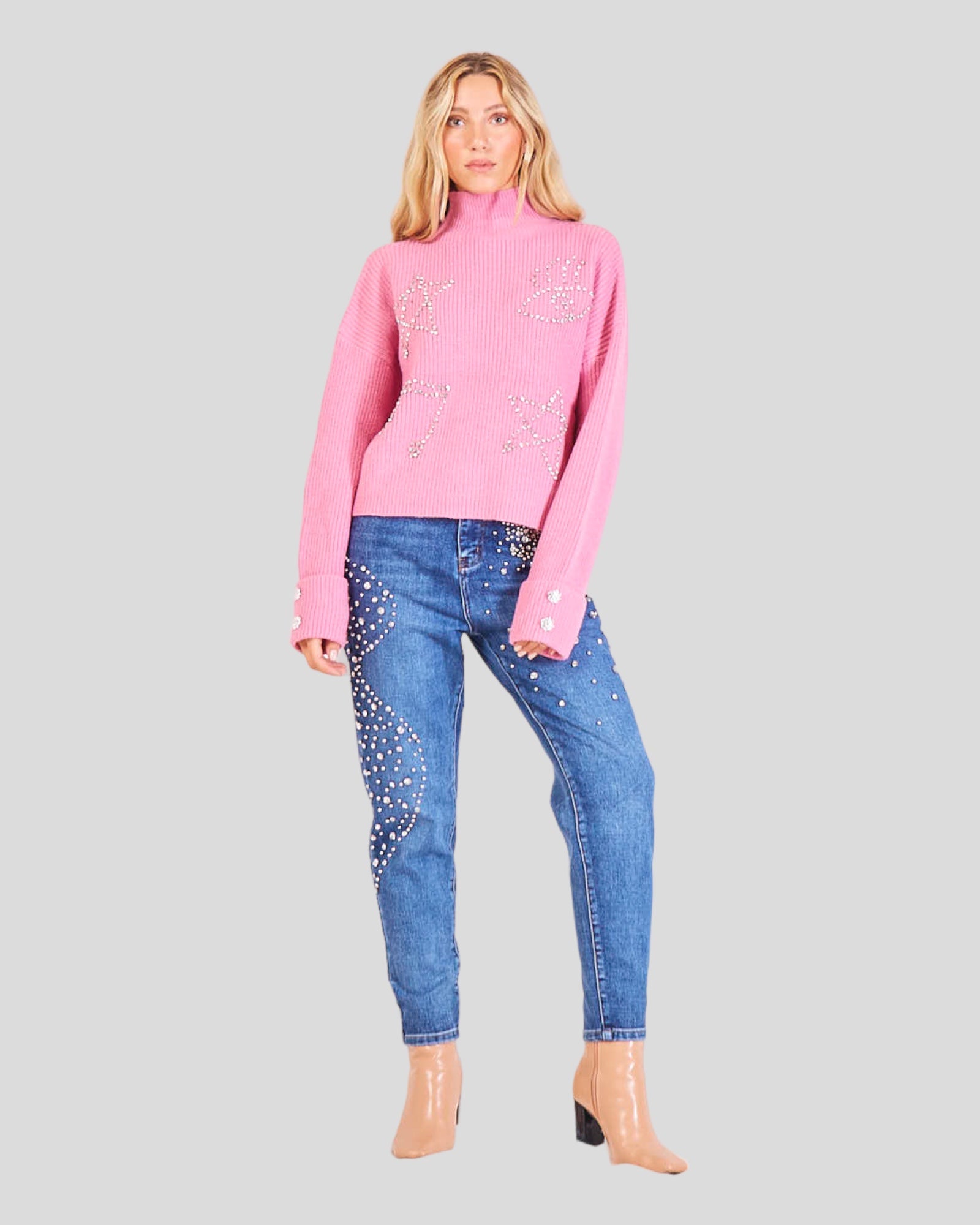 Sweater with a High Neck, Turn-Up Cuffs, and a Comfortable Straight Fit. The sweater is adorned with sparkling rhinestone applications on the front, and two large rhinestone buttons grace the turned cuffs, adding a touch of glamour. 