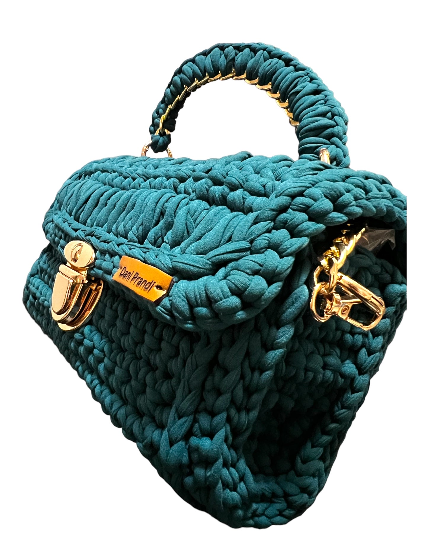 dark green luxury crochet bag with an exquisite design and a golden removable shoulder chain. The bag is a masterpiece of elegant craftsmanship, featuring meticulous crochet work that reflects a refined and sophisticated model. The versatile golden chain adds a touch of glamour, allowing for multiple styling options.