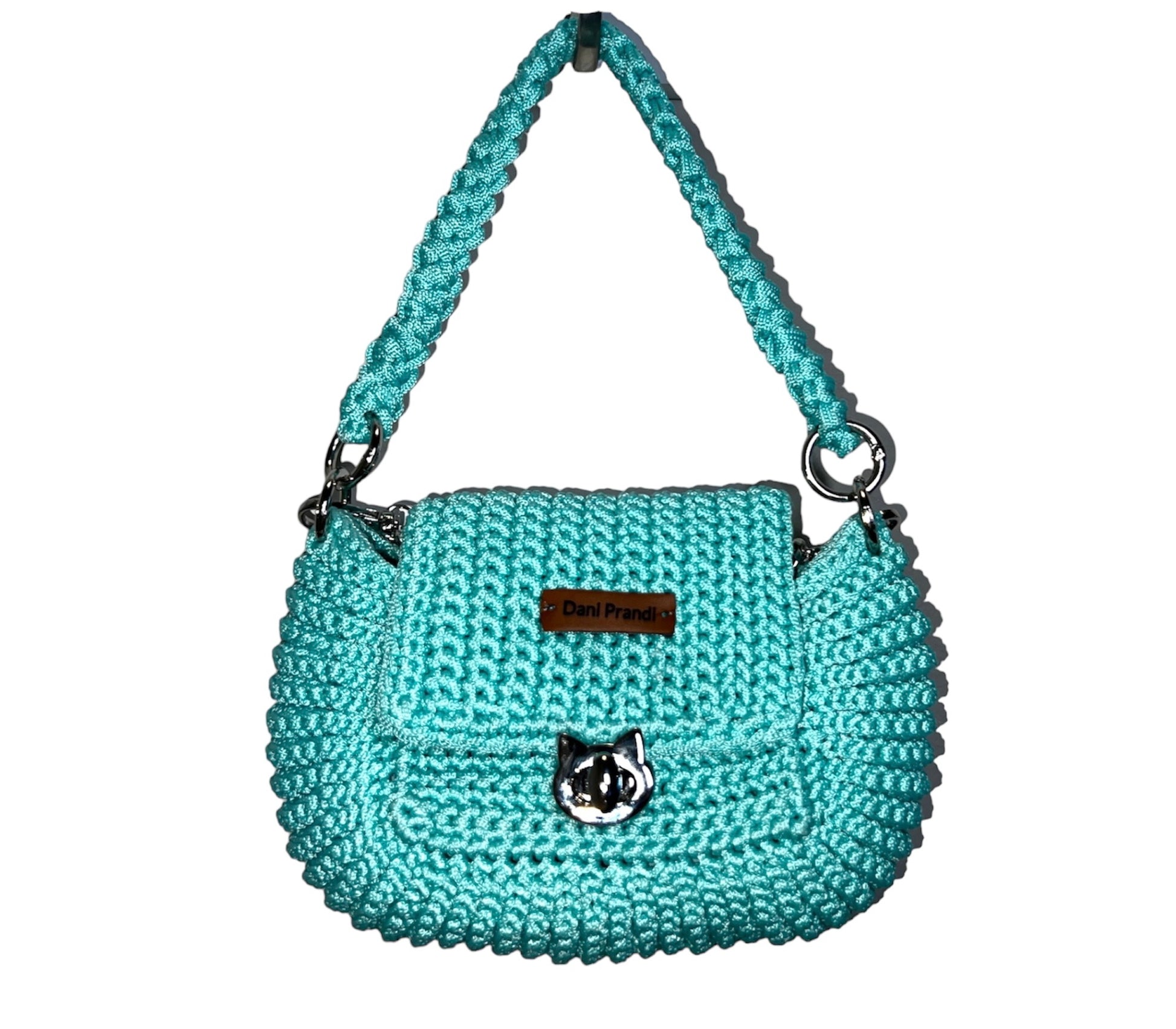 mini crochet embroidered bag in a captivating aqua green hue. The bag is adorned with a metal chain and features a closure bearing the distinctive symbol of our Catwalks Cat brand. Lined with luxurious acetinated fabric, this mini bag is a testament to unique craftsmanship and fashion sophistication.
